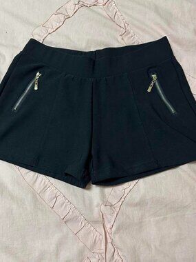Black shorts with gold zipper details.